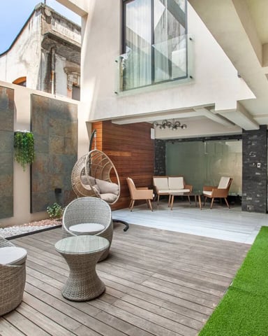 Building courtyard terrace with hanging chair and outdoor seating area