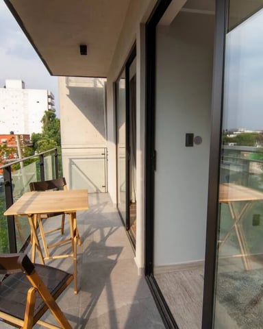 Wide rooftop balcony with panoramic view over Roma Norte rooftops